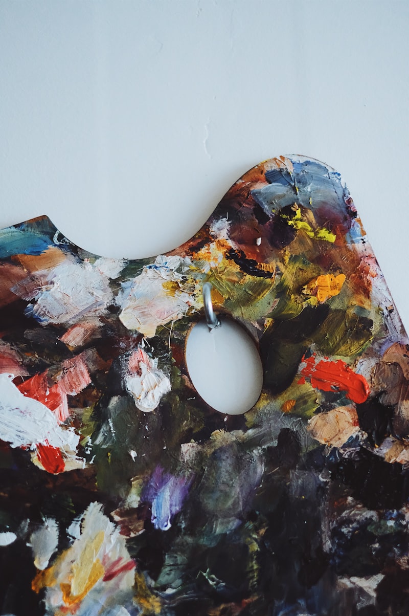 A heavily loaded painter's palette, thick with mixed greys, blues and ochres.